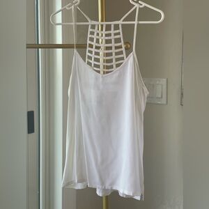 Spaghetti strap white tank top with net pattern on upper back of top